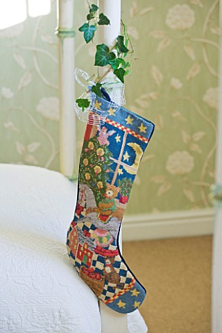 BRUERN_COTTAGES__OXFORDSHIRE_CHRISTMAS__CHRISTMAS_STOCKING_AT_THE_END_OF_THE_BED