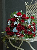 JUDITH BLACKLOCK: VALENTINES FLOWER ARRANGEMENT ON METAL CHAIR WITH ROSES  IVY BERRIES AND EUCALYPTUS