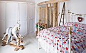 DESIGNER CAROLYN MINTY  GLOUCESTERSHIRE: BEDROOM WITH ROCKING HORSE AND BED