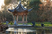 RHS GARDEN WISLEY  SURREY:  VIEW ACROSS THE LAKE AT SEVEN ACRES TO THE CHINESE PAGODA. WINTER  JANUARY.