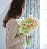 GIRL IN BATHROOM HOLDING AMARYLLIS - AMARYLLIS HIPPEASTRUM CHERRY BLOSSOM  AND CHALLENGER- STYLING BY JACKY HOBBS