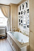 DESIGNER JANE CHURCHILL : MAIN BEDROOM EN SUITE BATHROOM WITH BLACK AND WHITE FAMILY PHOTOS ON THE WALL
