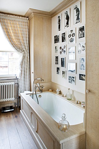 DESIGNER_JANE_CHURCHILL__MAIN_BEDROOM_EN_SUITE_BATHROOM_WITH_BLACK_AND_WHITE_FAMILY_PHOTOS_ON_THE_WA