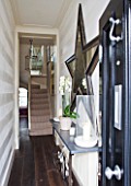 DESIGNER JANE CHURCHILL : NARROW HALLWAY HALLWAY LEADING TO DRAWING ROOM AND STAIRCASE