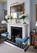 DESIGNER JANE CHURCHILL : THE DRAWING ROOM - MODERN FIREPLACE WITH ANTIQUE FRENCH CLOCK  ANTIQUE SHOP MIRROR AND GLASS VASES FROM JANE CHURCHILLS GRANDMOTHER