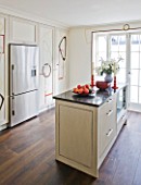 DESIGNER JANE CHURCHILL : THE KITCHEN WITH HAND PAINTED CUPBOARD DOORS BY BIANCA SMITH. GRANITE WORKTOP AND DARK STAINED FLOORBOARDS