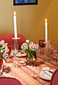 DESIGNER JANE CHURCHILL : THE DINING ROOM - MIXTURE OF IKEA AND WILLIAM YEOWARD GLASSES  VINTAGE PATTERNED DINNER PLATES. SILK TASSLE NAPKINS  CANDLES