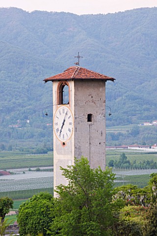 GARDEN_OF_PAOLO_PEJRONE__ITALY_VIEW_OF_THE_GARDEN_AND_CLOCK_TOWER__WITH_MOUNTAINS_BEHIND