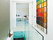 CAKE BOY HOUSE  LONDON: HALLWAY WITH ISABELLA KAY PAINTING  COMPRISING 50 MINI-CANVASES  WITH LIVING ROOM BEHIND