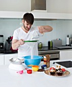 CAKE BOY HOUSE  LONDON: ERIC LANLARD  CAKE BOY  PREPARING A CAKE MIX IN HIS KITCHEN