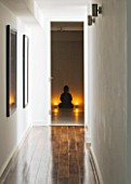CAKE BOY HOUSE  LONDON: LONG CORRIDOR IN BASEMENT LEADING TO GUEST BATHROOM - POLISHED WOODEN FLOOR AND BUDDHA STATUE