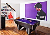 CAKE BOY HOUSE  LONDON: POOL ROOM IN BASEMENT WITH PURPLE POOL TABLE  BOOKSHOP AND JAMES DEAN PAINTING