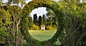 LES CONFINES  PROVENCE  FRANCE - DESIGNER: DOMINIQUE LAFOURCADE - VIEW OF FOLLY FRAMED BY CIRCLE OF HEDGE