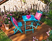 DECKING PROJECT - DESIGNER CLARE MATTHEWS - WOODEN DECK WITH BLUE TABLE AND CHAIRS AND PINK CUSHIONS