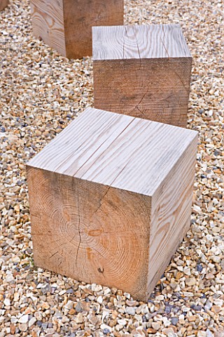 DECKING_PROJECT__DESIGNER_CLARE_MATTHEWS__SQUARE_WOODEN_BLOCKS_IN_GRAVEL_USED_AS_SEATING