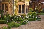 ASTHALL MANOR  OXFORDSHIRE: BOX HEDGING AND PEONIES AROUND THE FRONT OF THE HOUSE
