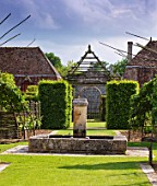 PRIEURE NOTRE-DAME DORSAN  FRANCE: THE CLOISTER - THE FOUNTAIN AND HEDGES OF HORNBEAM