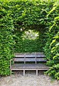 PRIEURE NOTRE-DAME DORSAN  FRANCE: SEAT SET INTO HEDGE WITH WINDOW CUT INTO HEDGE