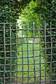 PRIEURE NOTRE-DAME DORSAN  FRANCE: WOODEN GATE BY THE THREE ORCHARD CLOISTER