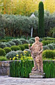 DESIGNER MICHEL SEMINI  PROVENCE  FRANCE: MAS THEO - THE SWIMMING POOL GARDEN WITH STATUE OF NEPTUNE  IRISES AND PARTERRE OF CLIPPED TEUCRIUM FRUTICANS AND SANTOLINA