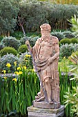 DESIGNER MICHEL SEMINI  PROVENCE  FRANCE: MAS THEO - THE SWIMMING POOL GARDEN WITH STATUE OF NEPTUNE  IRISES AND PARTERRE OF CLIPPED TEUCRIUM FRUTICANS AND SANTOLINA