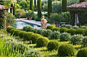 DESIGNER MICHEL SEMINI  PROVENCE  FRANCE: MAS THEO - THE SWIMMING POOL GARDEN WITH STATUE OF NEPTUNE AND PARTERRE OF CLIPPED TEUCRIUM FRUTICANS AND SANTOLINA