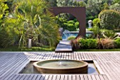 DESIGNER DOMINIQUE LAFOURCADE  PROVENCE  FRANCE: MODERN CONTEMPORARY GARDEN - DECKING  WATER FEATURE  METAL OCULUS CIRCLE AND SWIMMING POOL