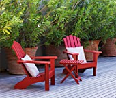 DESIGNER DOMINIQUE LAFOURCADE  PROVENCE  FRANCE: MODERN CONTEMPORARY GARDEN - DECKING TERRACE WITH RED WOODEN CHAIRS