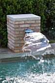 DESIGNER DOMINIQUE LAFOURCADE  PROVENCE  FRANCE: SWIMMING POOL WITH SQUARE BRICK FOUNTAIN THAT SPURTS RE-CYCLED WATER