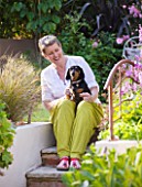 BARBARA KENNINGTON GARDEN  BRIGHTON: BARBARA ON THE STEPS WITH HER PET DACHSUND DOG BERTIE