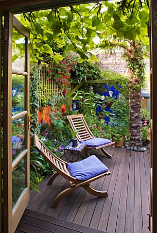 KARLA_NEWELL_GARDEN__BRIGHTON_VIEW_OUT_OF_HOUSE_TO_TERRACE_IN_SMALL_TOWN_GARDEN_WITH_ORANGE_WALL__DE