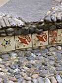 KARLA NEWELL GARDEN  BRIGHTON: SMALL TOWN GARDEN - SMALL STEP DECORATED WITH MEXICAN TILES AND PEBBLES