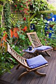 KARLA NEWELL GARDEN  BRIGHTON: SMALL TOWN GARDEN - DECKED TERRACE WITH WOODEN DECK CHAIRS WITH BLUE CUSHIONS - ORANGE RENDERED WALL