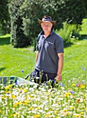 WHATLEY MANOR  WILTSHIRE: HEAD GARDENER BARRY HOLMAN IN THE SPA GARDEN WITH  ANNUAL WILDFLOWER MEADOW