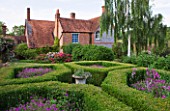 HOOK END FARM  BERKSHIRE: THE BOX PARTERRE WITH GERANIUM PATRICIA  ALLIUMS AND PERENNIAL SWEET PEAS WITH FARMHOUSE BEHIND