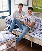 CHANTAL COADY HOUSE  LONDON: CHANTAL AND SON FERGUS  14 - ON SOFA AND BANQUETTE IN ROCOCO CHOCOLATES FABRIC IN LIVING ROOM