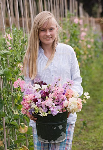 THE_GARDEN_AND_PLANT_COMPANY__HATHEROP_CASTLE__CIRENCESTER__GLOUCESTERSHIRE_GIRL_WITH_BUCKET_FULL_OF
