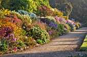 WATERPERRY GARDENS  OXFORDSHIRE: VIEW OF THE LONG BORDER AT DAWN IN AUTUMN