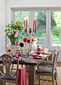 JACKY HOBBS HOUSE  LONDON: AUTUMN TABLE SETTING WITH MIXTURE OF BRIGHT SEASONAL DAHLIAS DRESSING THE TABLE WITH COLOURED CANDLES AND NAPKINS