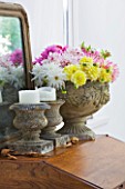 JACKY HOBBS HOUSE  LONDON: STONE INDOOR URN FILLED WITH MIXED DAHLIA BOUQUET WITH STONE CANDLE PLINTHS AND MIRROR ON WOODEN DESK