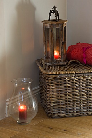 JACKY_HOBBS_HOUSE__LONDON_WICKER_BASKET_RED_THROW_AND_WOODEN_AND_GLASS_STROM_LANTERNS_WITH_CANDLES
