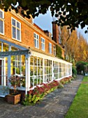 SALING HALL  ESSEX:  HOUSE AND CONSERVATORY WITH IN AUTUMN COLOUR - EVENING LIGHT