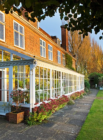 SALING_HALL__ESSEX__HOUSE_AND_CONSERVATORY_WITH_IN_AUTUMN_COLOUR__EVENING_LIGHT