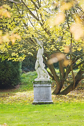 SALING_HALL__ESSEX_STONE_SCULPTURE_IN_THE_WOODLAND_IN_AUTUMN