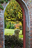 SALING HALL  ESSEX: VIEW THROUGH A GAET IN THE WALL INTO THE WALLED VEGETABLE GARDEN IN AUTUMN
