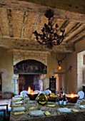 CHATEAU DU RIVAU  LOIRE VALLEY  FRANCE: DINING ROOM IN THE CHATEAU WITH TABLE LAID AND FIREPLACE