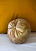 CHATEAU DU RIVAU  LOIRE VALLEY  FRANCE: PUMPKIN BESIDE PILLOW IN THE BRIDAL ROOM BEDROOM IN THE ROYAL STABLES