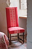CHATEAU DU RIVAU  LOIRE VALLEY  FRANCE: RED THEMED BEDROOM - RED CHAIR BY WINDOW