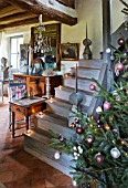 ROQUELIN  LOIRE VALLEY  FRANCE: CHRISTMAS TREE AT THE FOOT OF WOODEN STAIRCASE IN THE SITTING ROOM