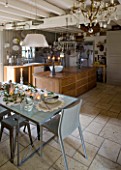 ROQUELIN  LOIRE VALLEY  FRANCE: ROQUELIN  LOIRE VALLEY  FRANCE: KITCHEN; ZINC TOP DINING TABLE WITH PAINTED WOODEN CHINA CABINET  MAIN KITCHEN ISLAND IS AN OLD SHOP COUNTER  WOODEN